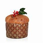 Christmas italian panetone cake with decorative wrapping and holly leaf sprig with berries, over white background.