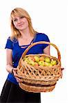 Woman in blue blouse standing and holding a basket full apples on white background. Beautiful girl holding a basket of delicious fresh fruits. Pretty girl with basket of apples. Isolated over white.