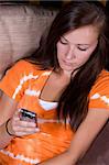 Girl at Home texting sitting on the couch