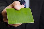 Man giving out a green business card