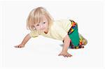 boy with long blond hair crawling on the floor - clipping path