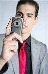 Businessman with gray suit taking photos with phone camera