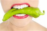 Beautiful woman teeth eating green vegetable raw pepper