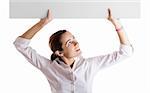 Portrait of a beautiful woman holding a blank billboard over her head