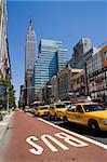 many yellow cabs in manhattan street in new york