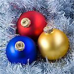 Colorful christmas balls in silver garland background