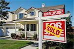 Sold Foreclosure Home For Sale Sign in Front of Beautiful House.