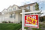 Sold Home For Sale Sign in Front of Beautiful New House.