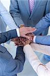Close-up of international businesspeople with hands together