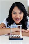 Businesswoman playing with Newton balls in office