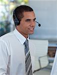 Hispanic businessman with a headset on working in a call center