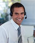 Attractive businessman with a headset on working in a call center