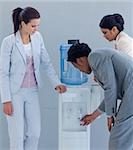 Young business colleagues talking around a water cooler