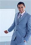Young businessman pointing at a whiteboard in a presentation