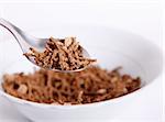 Brown fiber cereal. Spoon and dish objects