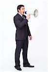 Standing businessman shouting through a megaphone agaisnt white
