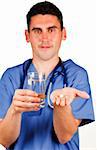 Young doctor holding a pill and a glass of water