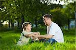 Conversation of father and small son in a summer garden