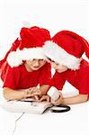 Two little boys in caps of santa dial a phone number, isolated