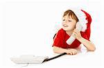 Little boy in a cap of santa calls by phone, isolated