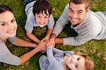 Smiling family relaxing in a garden