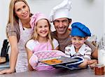 Smiling family baking cookies in the kitchen