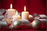 Christmas decoration with candles and ribbons / red and silver