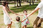 Young family embracing and enjoying with two young children