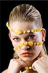 beauty shot close up of a pretty young blond woman with a yellow stones necklace around her face