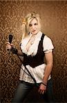 Pretty young female blonde singer or comedian with microphone