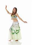 Young Caucasian belly dancing girl in beautiful decorated clothes on white background and reflective floor. Not isolated