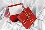 red gift box on white satin background