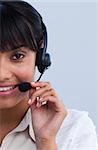 Close-up of smiling ethnic young businesswoman working in a call center