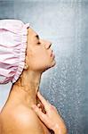 girl with a cap on her head  in the shower