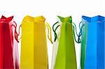 Closeup of four brightly colored shopping bags.  Shot on white background.