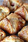 Sesame puff pastry envelopes stuffed with ham, salami and cheese. Shallow DOF