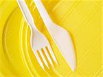 yellow disposable plates with fork and knife