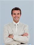 Portrait of smiling young businessman with folded arms