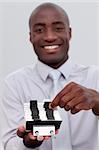 Afro-American businessman looking at an index holder in the office