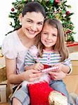 Happy mother and daughter at home at Christmas time