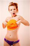 Funny portrait of young woman in orange colors