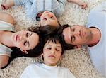 Young Family sleeping on the floor with heads together