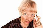 Skeptical senior woman looking over the top of her glasses