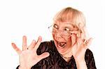 Shocked senior woman looking sideways over the top of her glasses