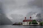 An orthodox church on lake shore on a stormy day