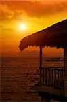 tropical sea bungalow' porch  at sunset