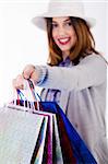 Women showing her shopping bags after her purchase is over indoor studio