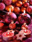 Detail of delicious Christmas cookies with candles in violet tone