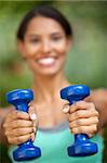 Young woman exercising in outdoor setting. Vertically framed shot.