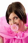 funny shot of a young girl with pink collar paper keeping a pink flower in her mouth
